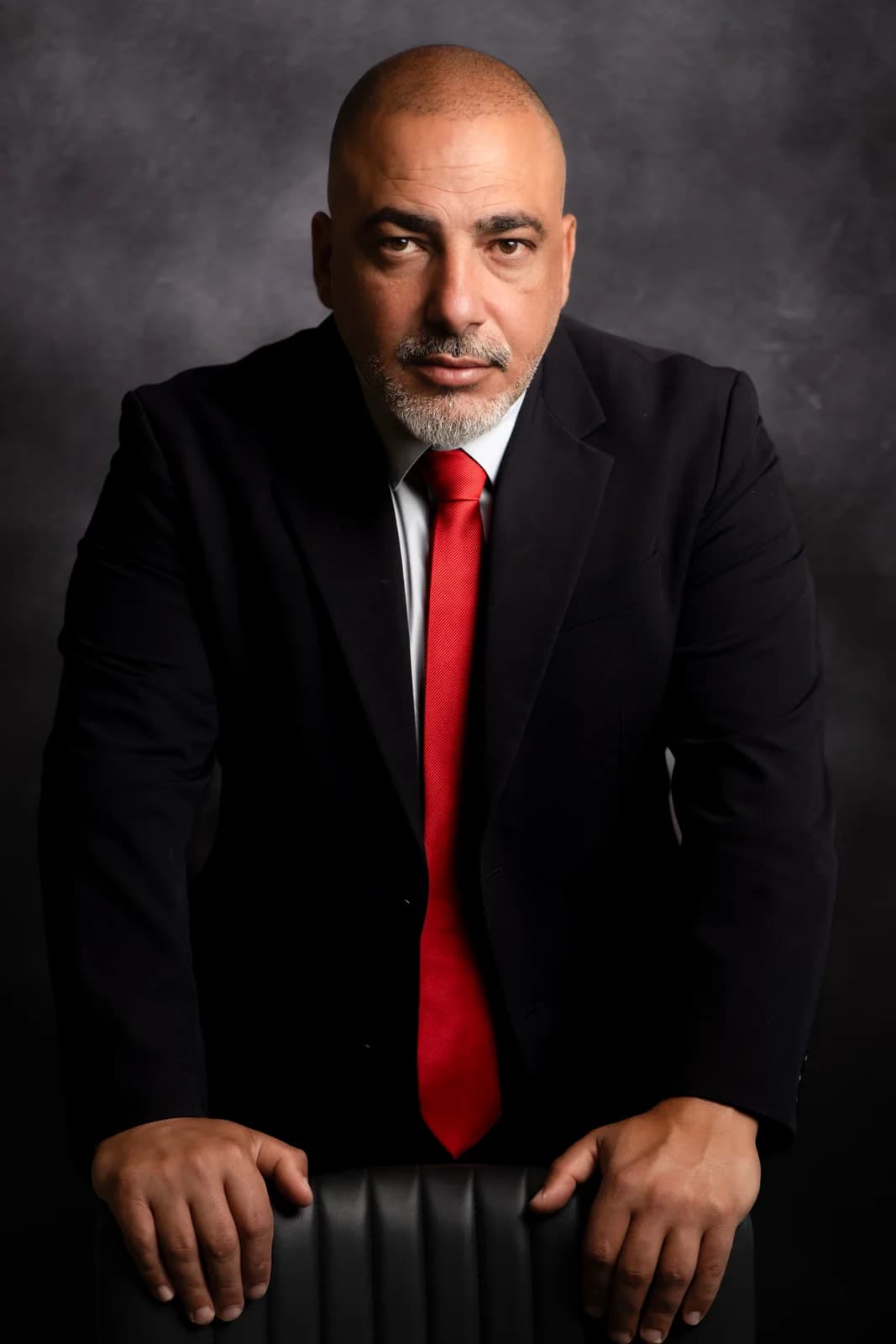 Studio portrait in a dark suit and red tie — headshots for men, Sharon Gabay
