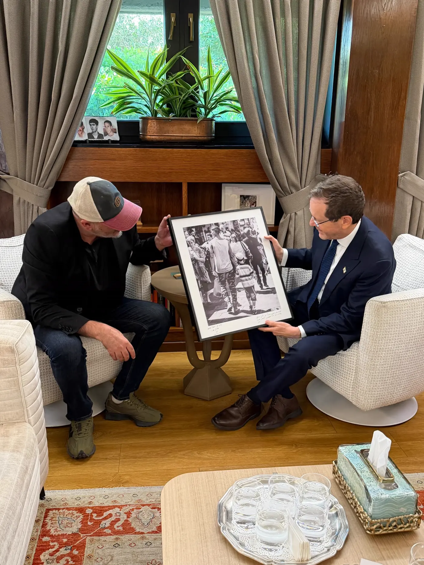 Sharon Gabay and President Isaac Herzog looking at a signed print at the President's Residence