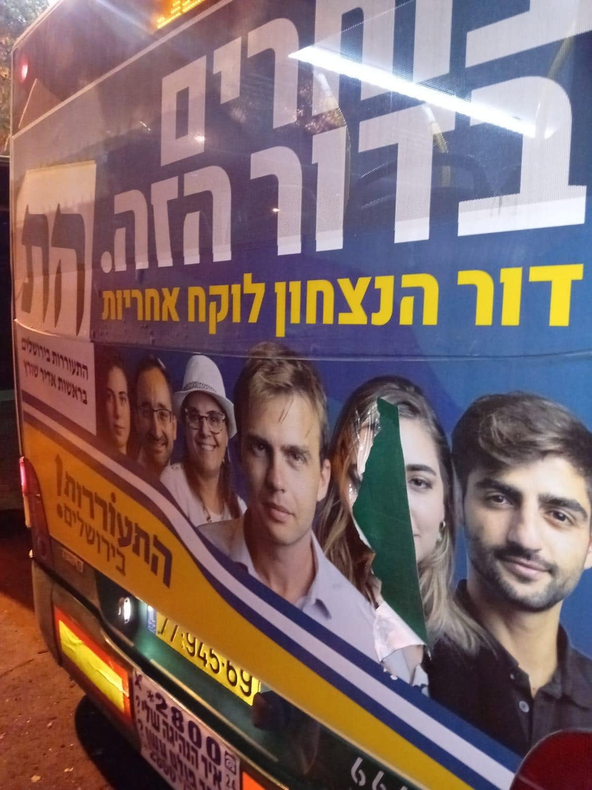 An advertisement on a bus with a woman's face torn out — defacement of women's images in public space