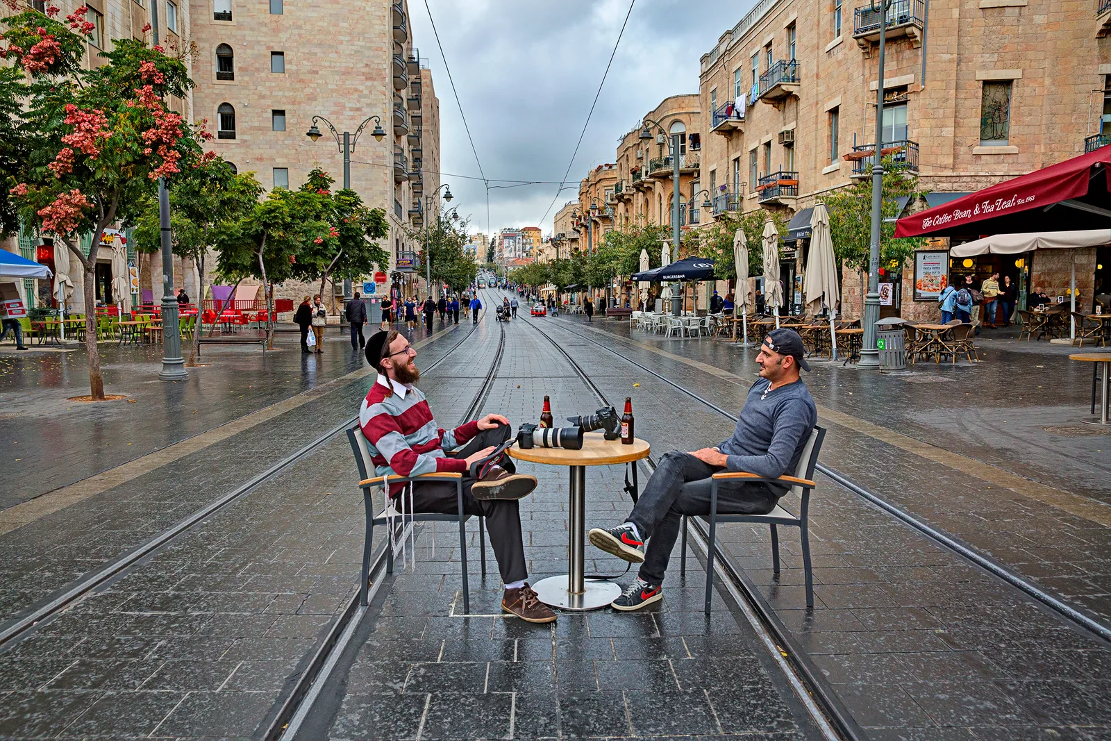 A shared table on the Jaffa Street light-rail tracks — the signature work of the “Off the Rails” exhibition by Sharon Gabay & Ezra Landau