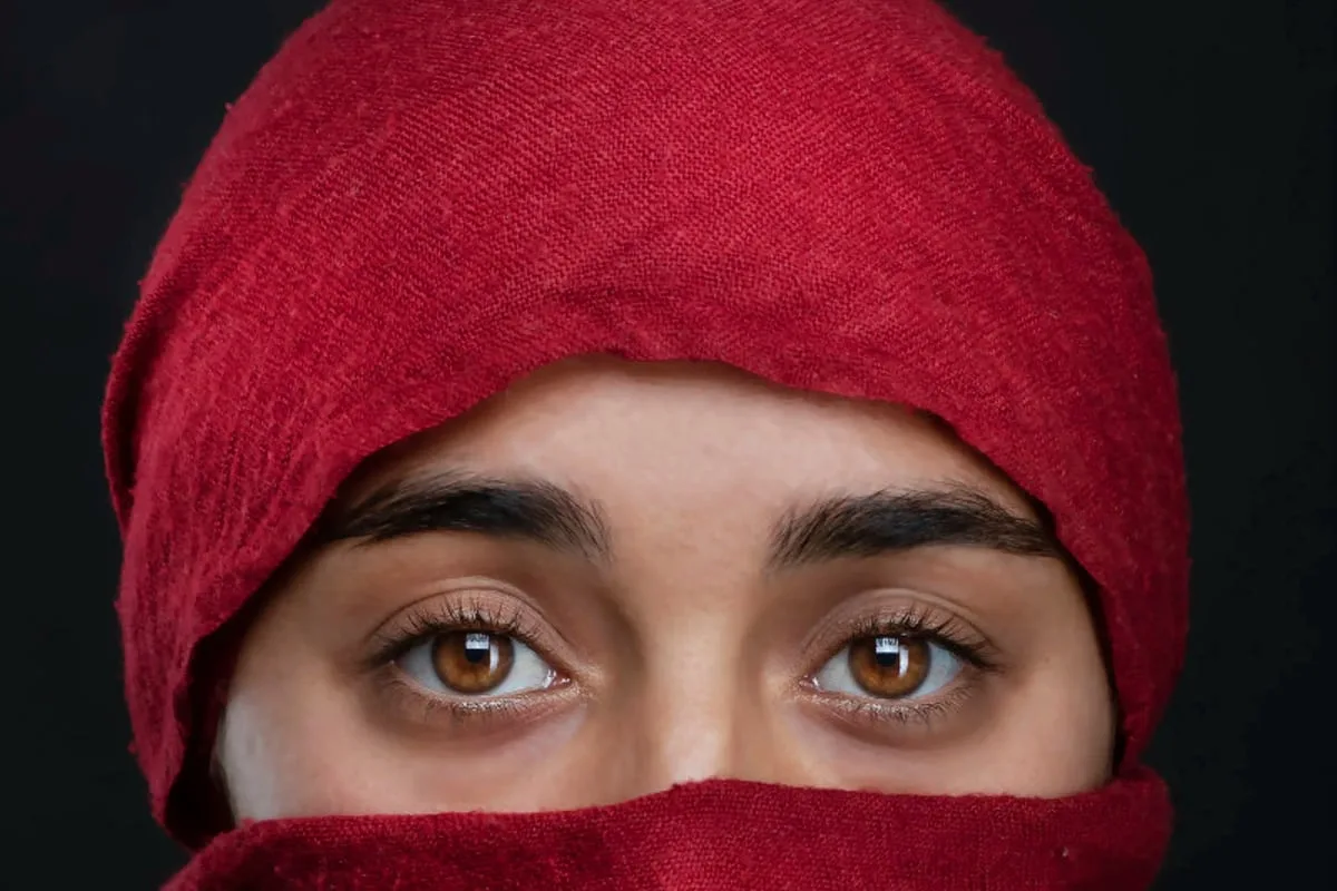 Headshot of an actress — a piercing gaze through a red scarf, a presence that stops you — Sharon Gabay, headshot photographer