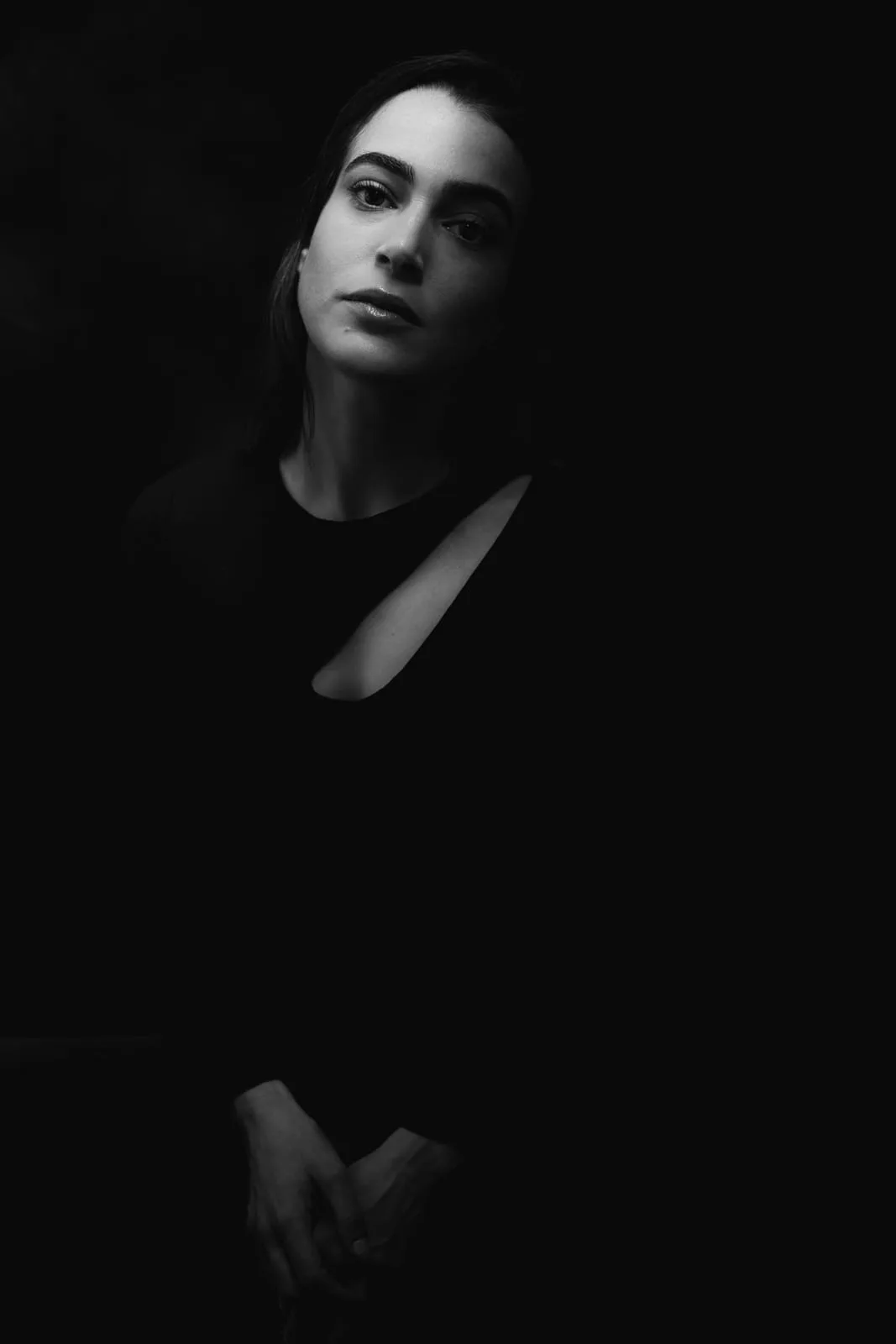 Dramatic personal studio portrait — a face in focused light on a black background | Photo: Sharon Gabay