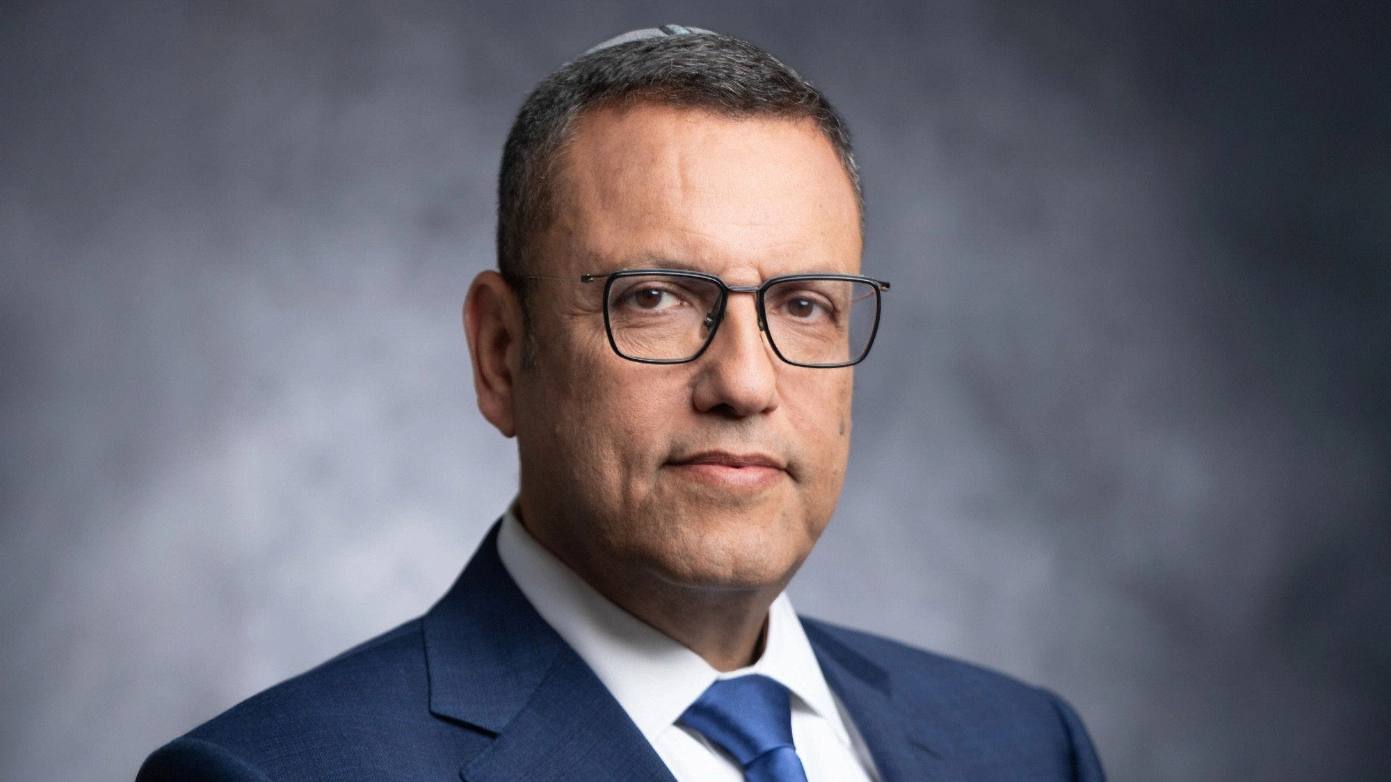 A polished business headshot of Jerusalem Mayor Moshe Lion, upright posture and a direct gaze projecting authority — Sharon Gabay, headshot photographer