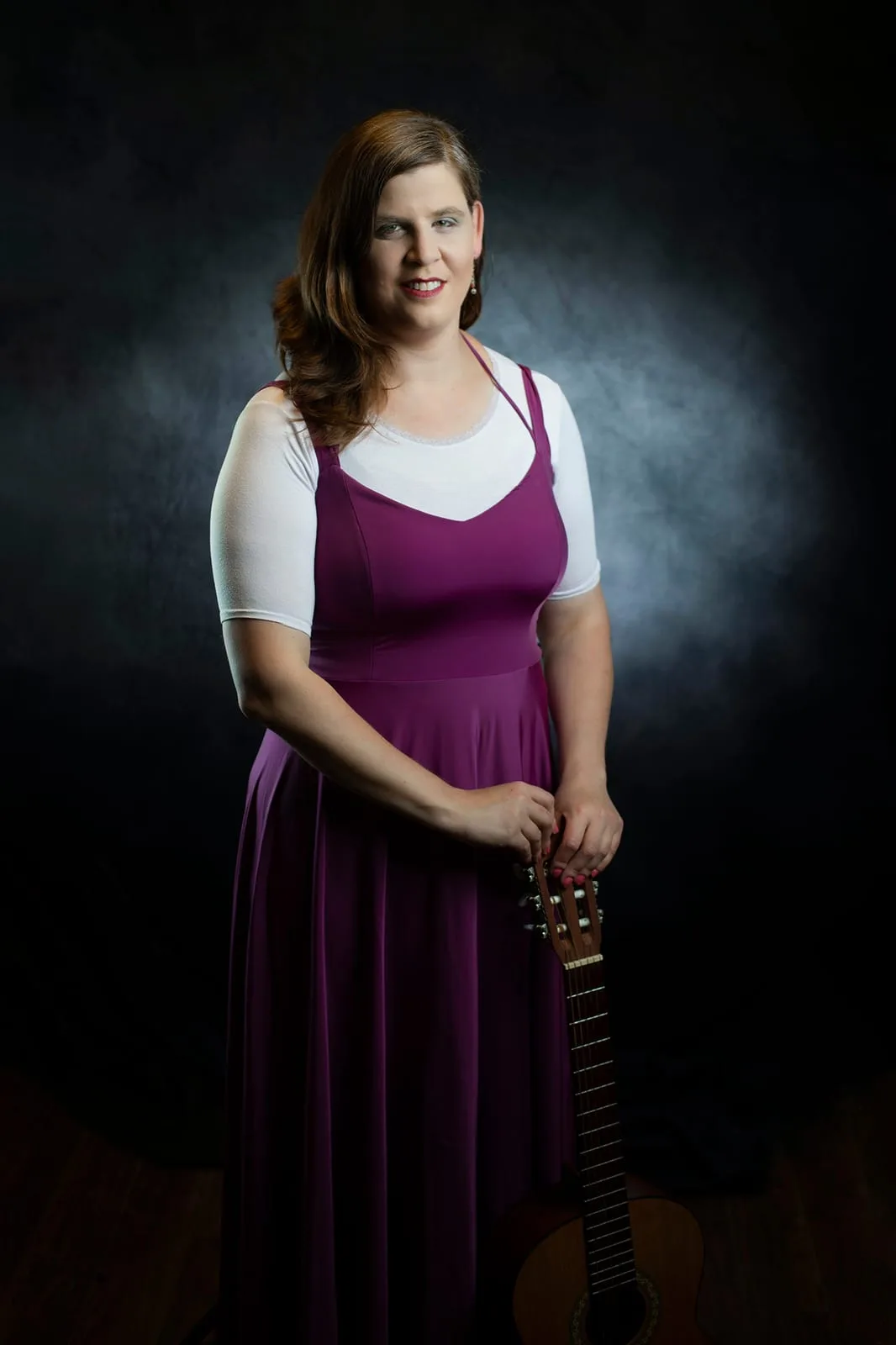 Headshot of a singer-songwriter with a guitar in a purple dress and warm lighting — Sharon Gabay, headshot photographer